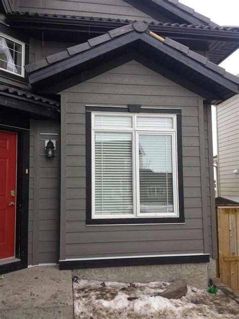 pictures of gray houses with metal roofs|gray exterior with black trim.